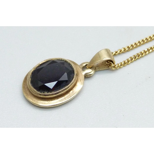 1026 - A 9ct gold and garnet pendant on a fine 9ct gold chain, 4g, chain 45cm