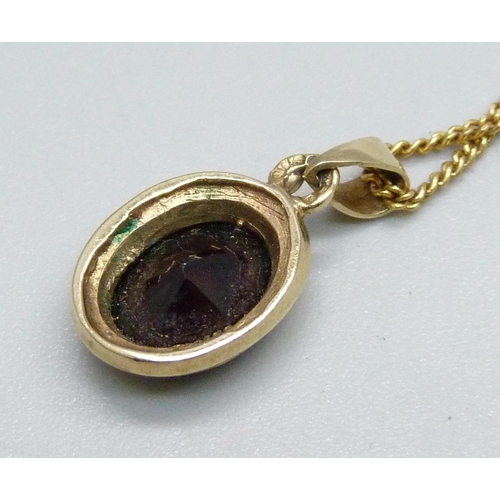 1026 - A 9ct gold and garnet pendant on a fine 9ct gold chain, 4g, chain 45cm