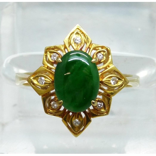 1028 - A 14ct gold and green stone ring also set with eight small diamonds, 3.5g, O/P, marked 585