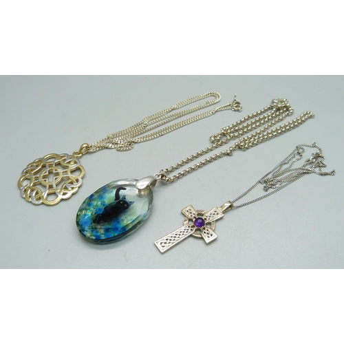 1039 - Two silver pendants and chains and a silver mounted cat pendant and chain