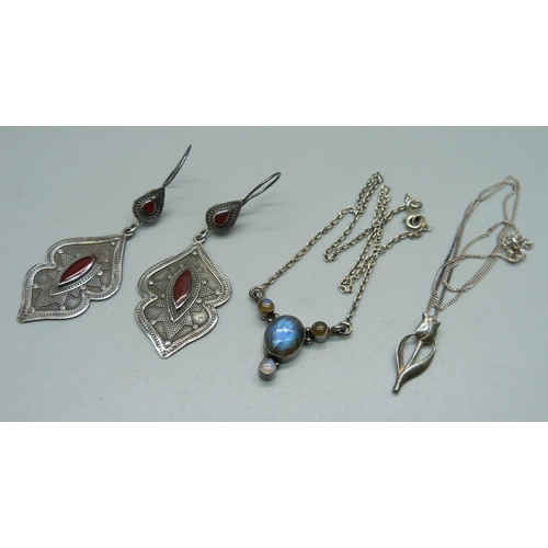 1042 - A silver pendant and chain, a silver necklet and a pair of silver earrings