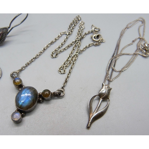 1042 - A silver pendant and chain, a silver necklet and a pair of silver earrings