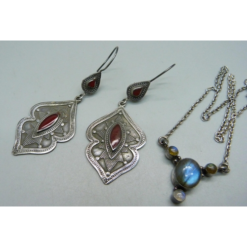 1042 - A silver pendant and chain, a silver necklet and a pair of silver earrings