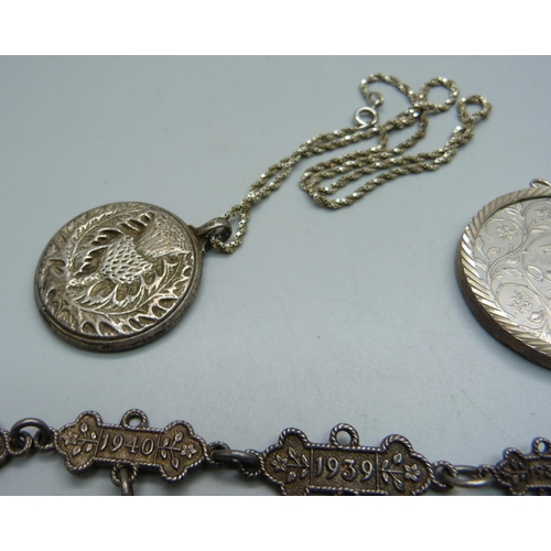 1043 - Silver St. John's year bars, 21.9g, a thistle pendant on a silver chain and a 1977 crown in a silver... 