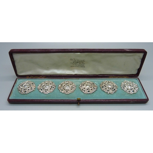 1044 - A cased set of six Victorian ornate silver buttons, Birmingham 1900, by Levi and Salaman, 28mm