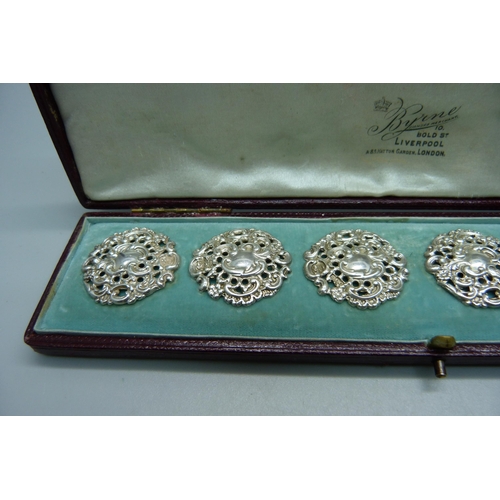 1044 - A cased set of six Victorian ornate silver buttons, Birmingham 1900, by Levi and Salaman, 28mm