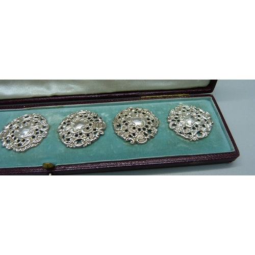 1044 - A cased set of six Victorian ornate silver buttons, Birmingham 1900, by Levi and Salaman, 28mm