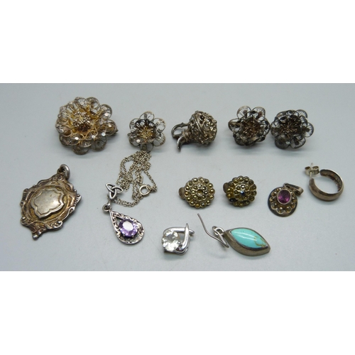 1047 - Three silver pendants, a filigree brooch and earrings, other earrings, a fob medal and a charm, (inc... 