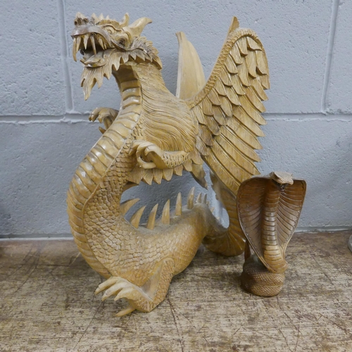 1062 - A carved model of a dragon and a cobra **PLEASE NOTE THIS LOT IS NOT ELIGIBLE FOR POSTING AND PACKIN... 