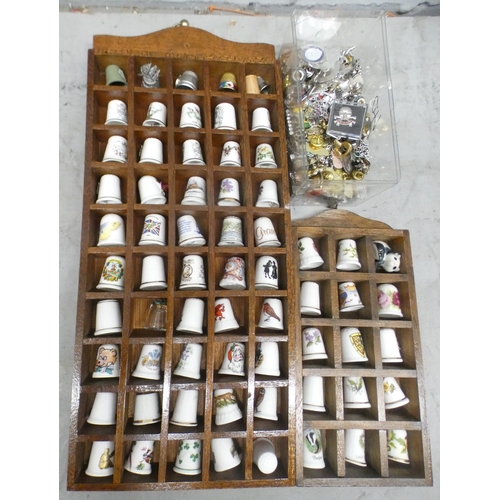 1065 - A collection of china thimbles, pins, charms and badges **PLEASE NOTE THIS LOT IS NOT ELIGIBLE FOR P... 