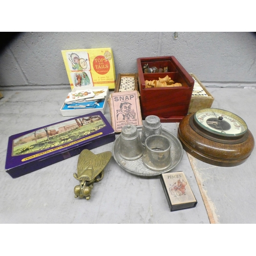 1102 - A box of assorted items including a chess set, two sets of dominoes, brass ashtray, barometer, pewte... 