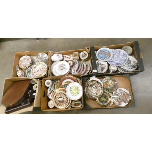 1112 - Six boxes of collectors plates, Sadler teapots and two display cabinets with miniature clocks and or... 