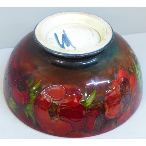 613 - An early 20th Century Moorcroft bowl, anemone pattern with flambe glaze, signed on the base, 23.5cm,... 