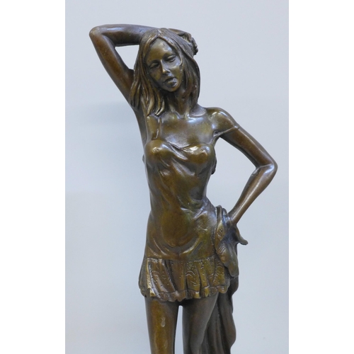 614 - A bronze statue of a lady on a marble base, signed, 30cm