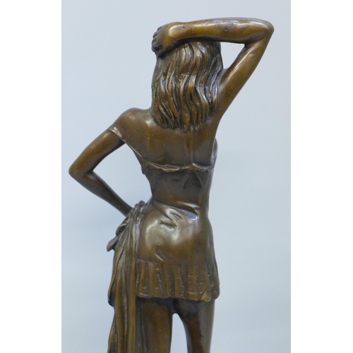 614 - A bronze statue of a lady on a marble base, signed, 30cm