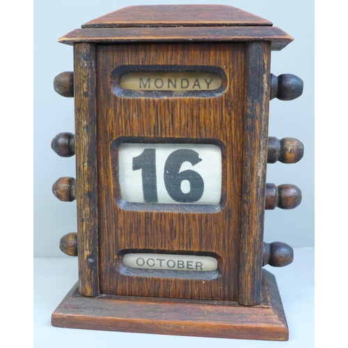 657 - A wood and linen perpetual desk calendar