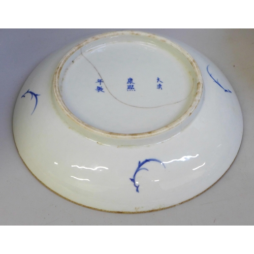 694 - A Chinese bowl with four character mark to base, a Chinese blue and white dish with six character ma... 