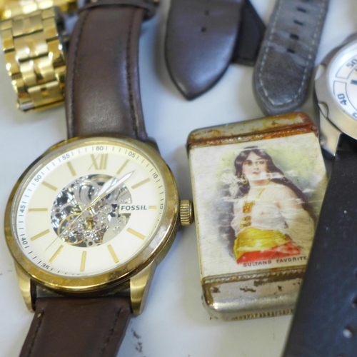 709 - A collection of wristwatches including Michael Kors, a cast brass figure, a vesta case, paperweight,... 