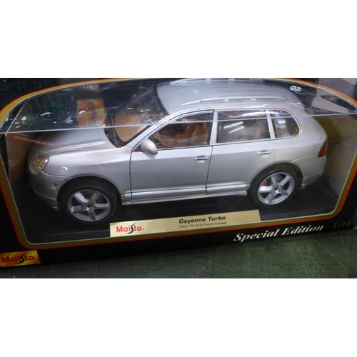 810 - Six 1:18 scale die-cast cars including Maisto and three other die-cast vehicles, boxed