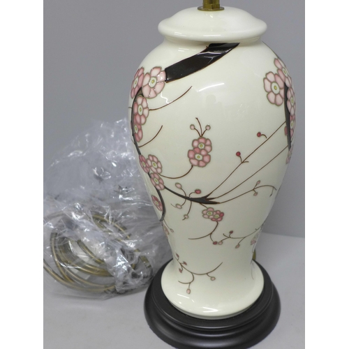 832 - A Moorcroft Sakura table lamp with shade, boxed