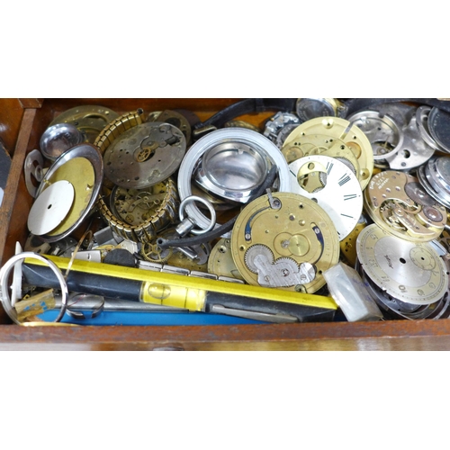 844 - A cabinet with drawers and lockable front with a collection of watch spares