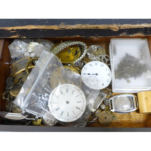 844 - A cabinet with drawers and lockable front with a collection of watch spares