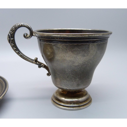 860 - An .800 silver cup and saucer, 79g