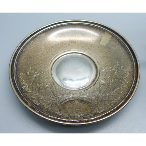 860 - An .800 silver cup and saucer, 79g