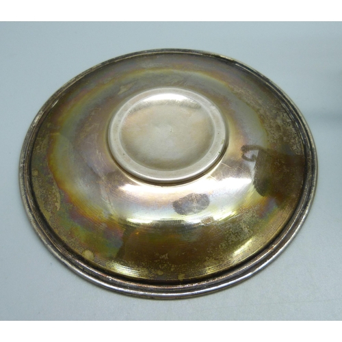 860 - An .800 silver cup and saucer, 79g