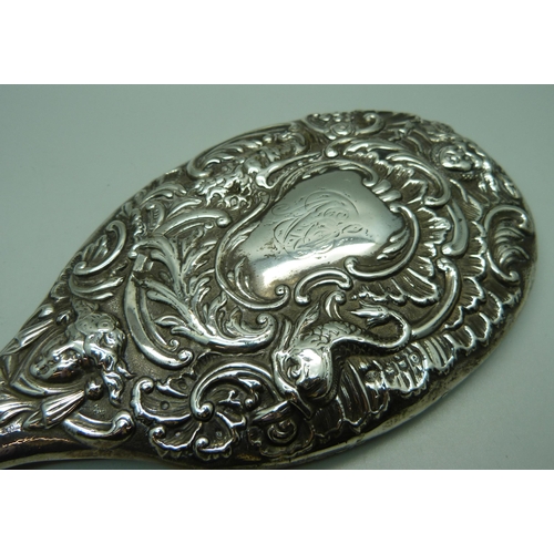 867 - A William Comyns embossed silver hand mirror, London 1900