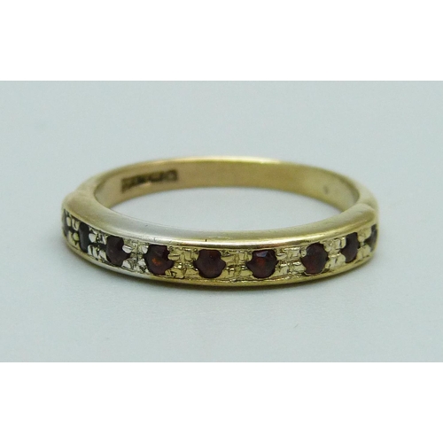 985 - A silver gilt, nine stone garnet half-eternity ring, M, stones worn