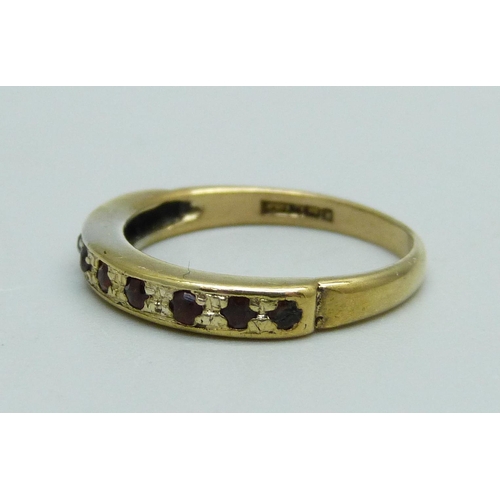 985 - A silver gilt, nine stone garnet half-eternity ring, M, stones worn