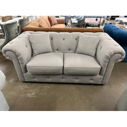 1469 - A grey upholstered Chesterfield two seater sofa