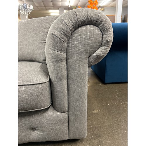 1469 - A grey upholstered Chesterfield two seater sofa