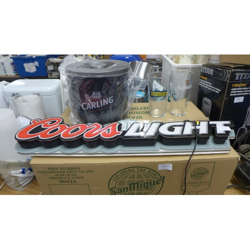 2395 - A 'Coors light' light up sign, ice bucket and box of brothers cider and Guinness glasses