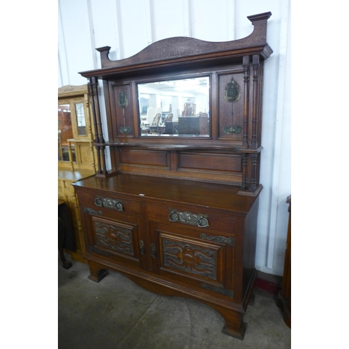 103 - An Arts and Crafts oak mirrorback sideboard