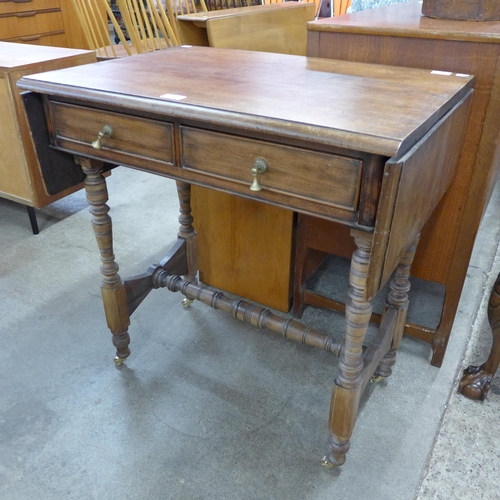 136A - A Victorian Aesthetic Movement mahogany two drawer drop-leaf side table