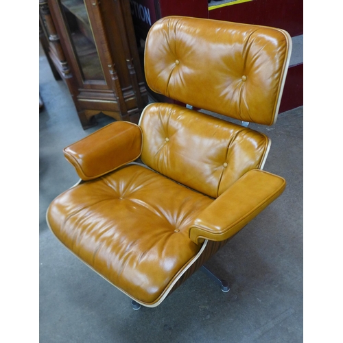 2 - A Charles & Ray Eames style simulated rosewood and tan leather revolving lounge chair and ottoman