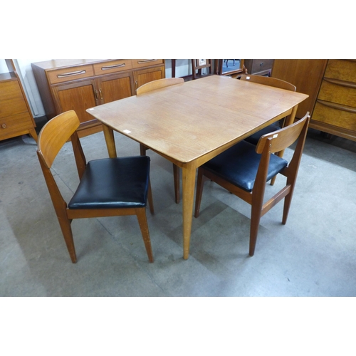 22 - A teak extending dining table and four chairs