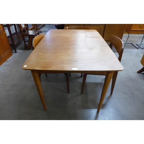 22 - A teak extending dining table and four chairs