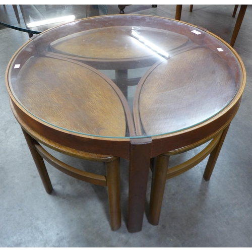 25 - A Nathan Trinity teak and glass topped circular nest of tables