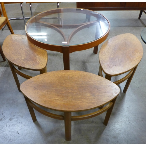 25 - A Nathan Trinity teak and glass topped circular nest of tables