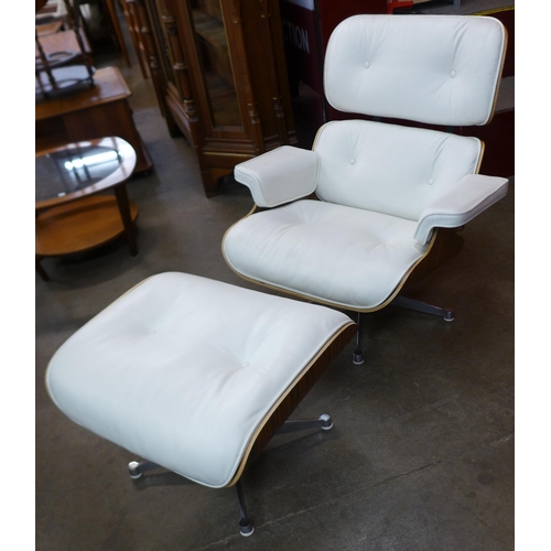 3 - A Charles & Ray Eames style simulated rosewood and white leather revolving lounge chair and ottoman