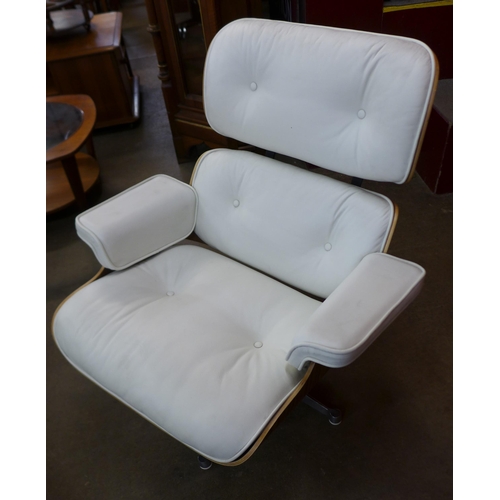 3 - A Charles & Ray Eames style simulated rosewood and white leather revolving lounge chair and ottoman