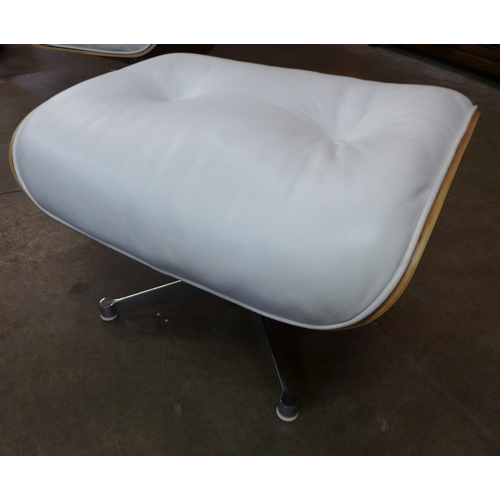 3 - A Charles & Ray Eames style simulated rosewood and white leather revolving lounge chair and ottoman