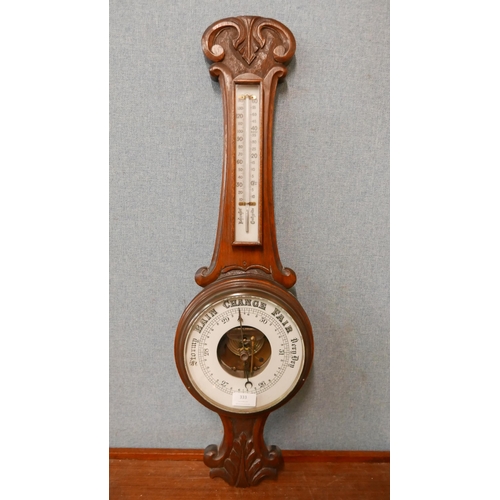 333 - An Edward VII carved oak aneroid barometer