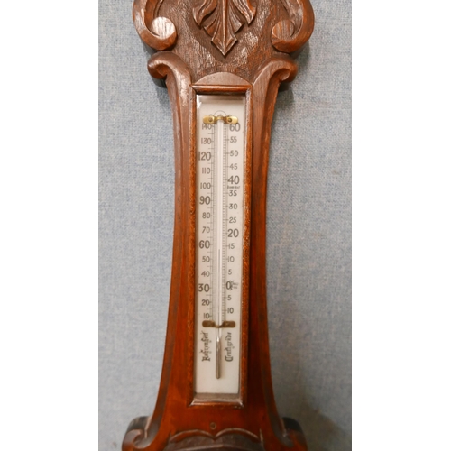 333 - An Edward VII carved oak aneroid barometer