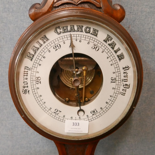 333 - An Edward VII carved oak aneroid barometer