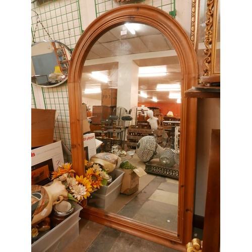 351 - A pine Cathedral style mirror and a carved walnut mirror