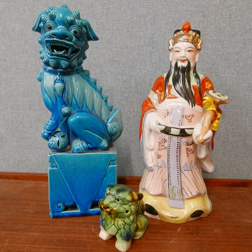 355 - A Chinese turquoise porcelain dog of foe, another dog of foe and a figure of a Chinese warrior